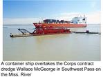 A container ship overtakes the Corps contract dredge Wallace McGeorge in Southwest Pass on the Miss. River